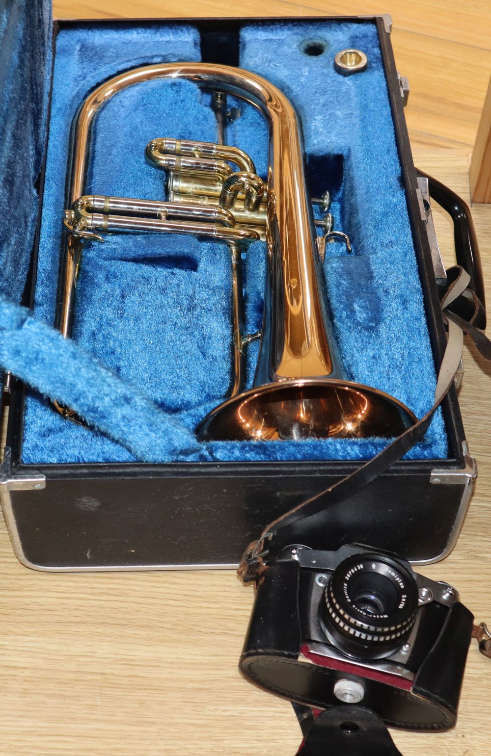 A Yamaha trumpet and a cased camera